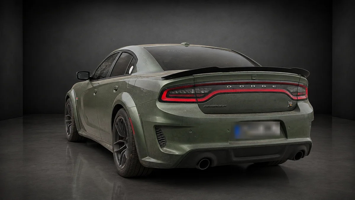 Dodge Charger Widebody in mattem Militärgrün, schräg von hinten links, mit Heckspoiler und Doppelendrohren